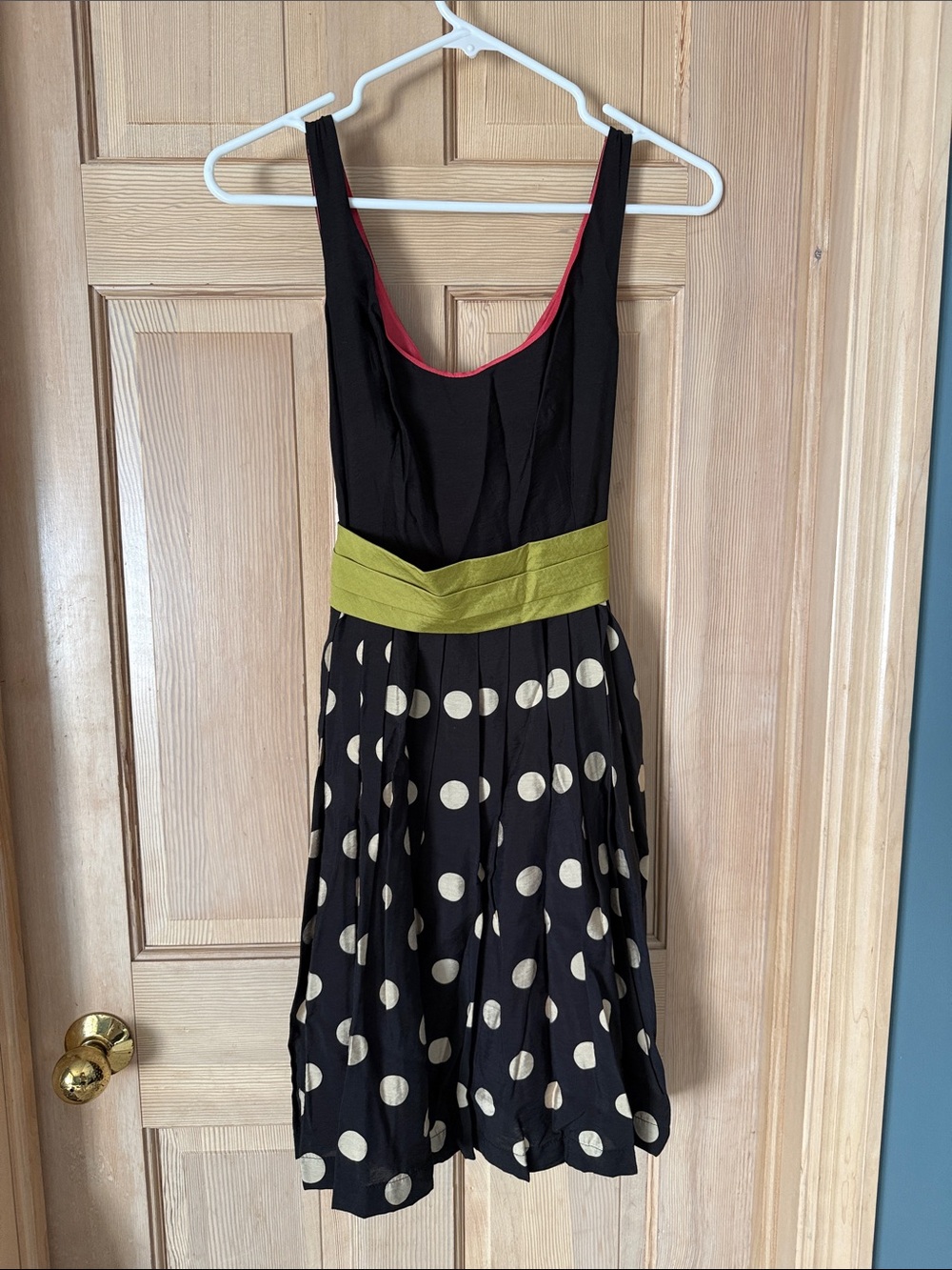 Sleeveless Black Polka Dot Midi Dress with Cream Dots and Green Waistband